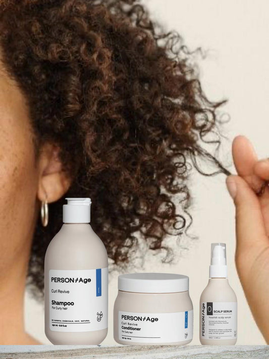 PersontAge CURL CARE & NOURISHMENT Ritual kit- hair care products on a surface with a person with curly hair in the background.