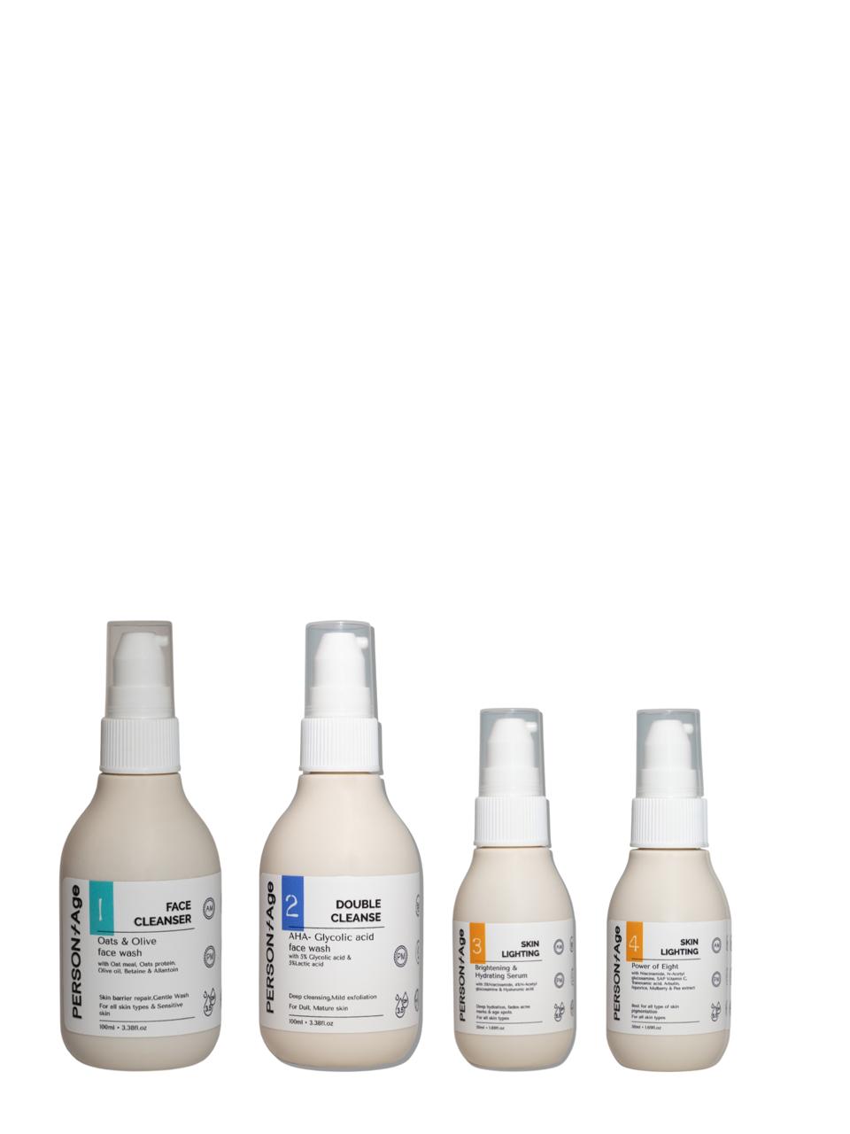 Four bottles of brightening skincare products ritual kit on a white background